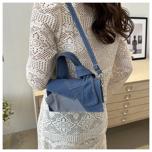 Retro denim patchwork crossbody bag with adjustable strap in blue deconstructed design