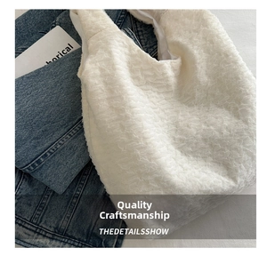 Detailed view of the white pleated cloud tote bag with premium textured fabric detail