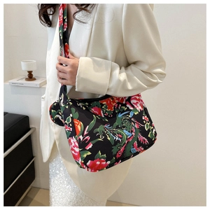 Detail of vibrant floral and phoenix embroidery on crossbody bag with wide strap