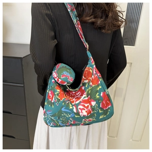 Close-up of floral nylon hobo bag with round mini pouch detail and vintage flower print