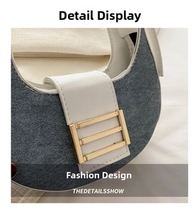 Detail of blue denim fabric with white leather trim and gold buckle on shoulder bag