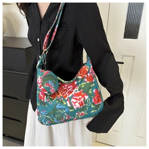 Detail of floral shoulder bag with matching coin purse shown on model shoulder