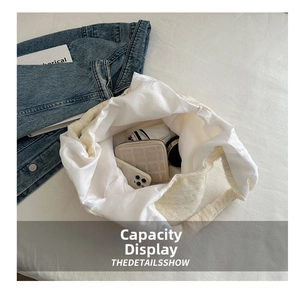 Spacious interior of white faux fur tote bag showing daily essentials capacity