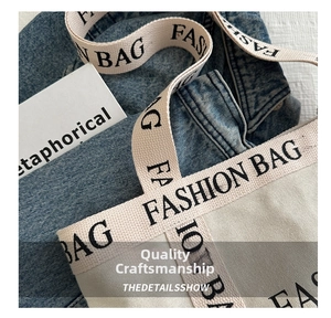 Close-up of canvas tote bag with fashion bag lettering handle on denim background