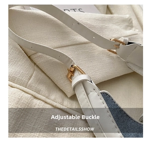 Close-up of white leather shoulder strap with adjustable golden buckle and stitching