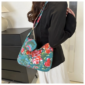 Detail of floral canvas shoulder bag with matching mini round pouch and red peony pattern