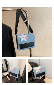 Detail of denim and leather crossbody bag with star patches and adjustable strap