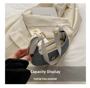 Detailed capacity display of denim and white leather crescent shoulder bag with interior view