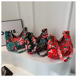 Three vibrant floral canvas tote bags with matching coin purses on white display tiers