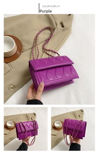 Detail view of purple quilted handbag with water drop pattern and gold chain strap