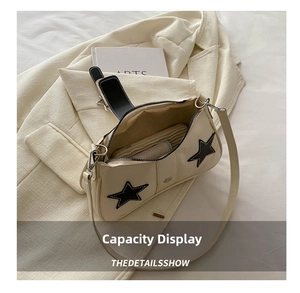 Detail view of the beige star shoulder bag showing internal storage capacity