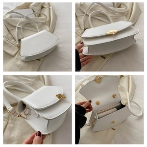 Détails du sac à main trapèze blanc avec ferrures dorées et compartiment intérieur