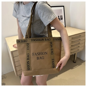 Close-up of a large khaki canvas tote bag with black Fashion Bag typography lettering