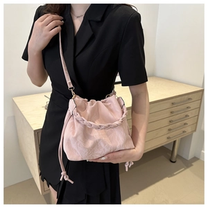 Detail of pink marble pattern bucket bag with woven handle and drawstring closure