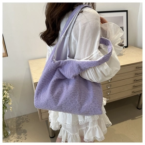 Detailed side view of lavender pleated tote bag with 3D bubble texture worn on shoulder