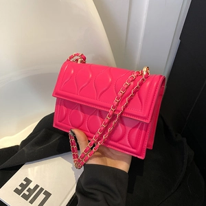 Magenta quilted crossbody bag with golden chain strap and leaf pattern stitching