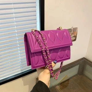 Burgundy quilted crossbody bag with gold chain strap and elegant water-drop pattern