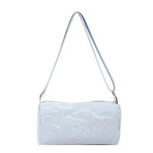 Minimalist light blue cylindrical pillow bag with natural pleated texture and gold hardware