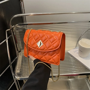 Orange quilted shoulder bag with gold chain strap and diamond metal turn-lock closure