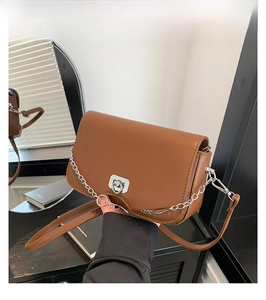Detail view of coffee leather crossbody bag with silver metal ring buckle and chain