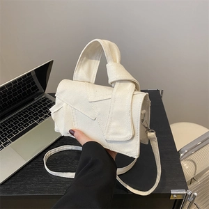 Minimalist canvas patchwork handbag with knotted handle and crossbody strap in white