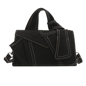 Modern black canvas crossbody bag with white contrast stitching and geometric design