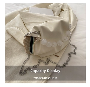 Detail view of cream PU leather bucket bag showing interior space for phone and card holder