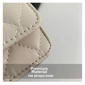 Macro view of beige quilted leather bag showing fine stitching and grain texture