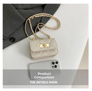 Mini cream quilted chain bag detail with gold clasp next to smartphone for scale