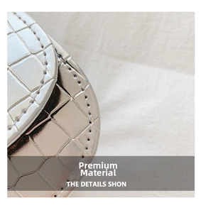 Detail of silver crocodile-embossed faux leather texture and neat stitching on shoulder bag