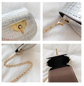 Detail showing silver crocodile texture, golden metal clasp and chain strap of mini bag