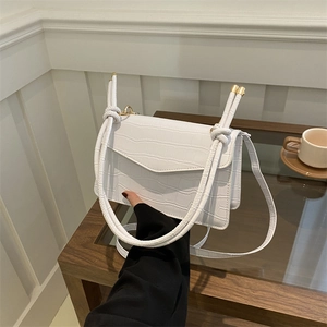 Chic white croc-embossed shoulder bag with gold hardware and knot strap detail