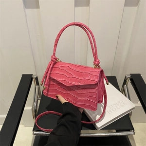 Magenta faux crocodile leather crossbody bag with knot handle and adjustable strap