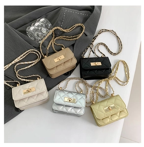 Detail view of five quilted mini crossbody bags in various colors with chain straps