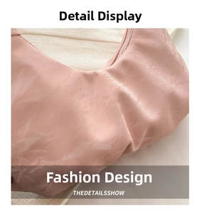 Close-up of pink pleated textured shoulder bag with silky nylon fabric and zipper detail