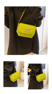Detail of neon green quilted bag featuring a silver metal bow and golden chain strap