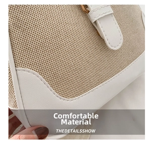 Detail of beige woven fabric with white leather trim and golden metal hardware