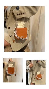 Brown box cross-body bag with rich rabbit embossing shown in shoulder, hand, and cross-body styles