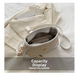 Detail showing the inner capacity of a beige woven crossbody bag with phone inside