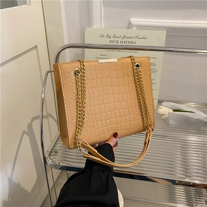 Chic cream crocodile pattern crossbody bag with golden chain and leather handle