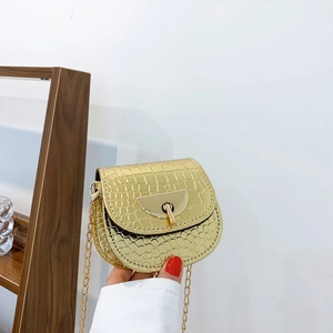 Mini gold crocodile pattern crossbody saddle bag with metallic chain strap and twist lock