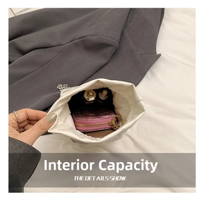 Internal view of a white drawstring bucket bag showing storage capacity for cosmetics