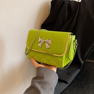 Vibrant lime green quilted chain bag with a metallic bow and elegant gold-tone trim