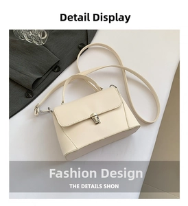 Detailed top view of cream square handbag with metal buckle and elegant leather texture