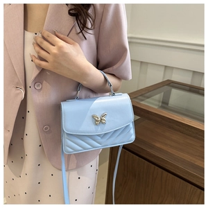 Light blue PU leather crossbody bag with silver butterfly buckle and V-quilted pattern