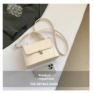 Detail view of cream vintage small square bag with silver metal buckle and handle