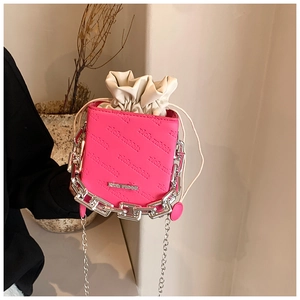 Close-up of pink bucket bag with rich rabbit embossed pattern and chunky silver chain