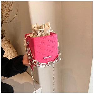 Pink cube bucket bag with rich rabbit embossed text and silver chain strap
