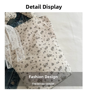 Detailed macro view of floral tote bag with textured fabric and white lace bow detail