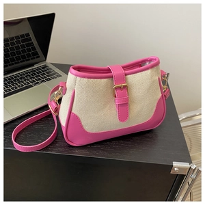 Detail of pink leather and canvas stitching on flap bag with gold buckle hardware